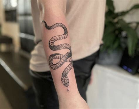 snake arm tattoo male.